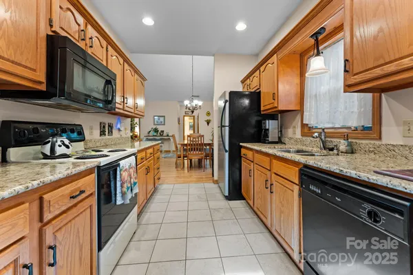 a view of a dining room with furniture a rug and wooden floor