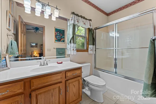 a bed room with a bed and a painting on the wall