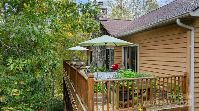 a living room with furniture a fireplace a flat screen tv and a large window