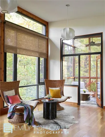 a living room with furniture and large windows