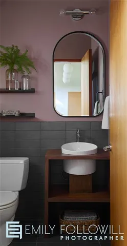 a bathroom with a sink a toilet and a mirror