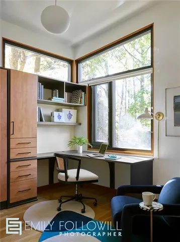 a room with furniture pool table and windows
