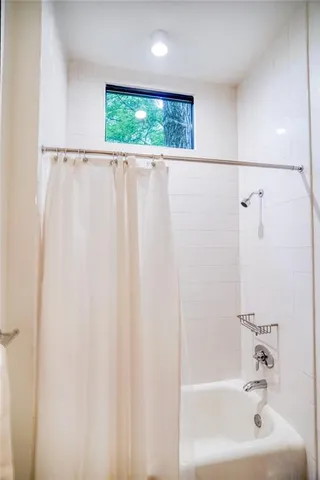 a bathroom with a shower and a sink