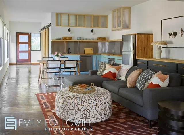 a living room with furniture and a fireplace
