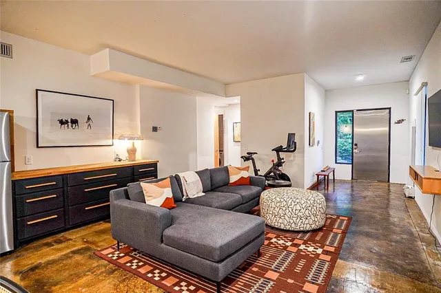a living room with furniture and wooden floor