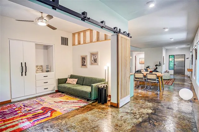 a living room with furniture and a rug