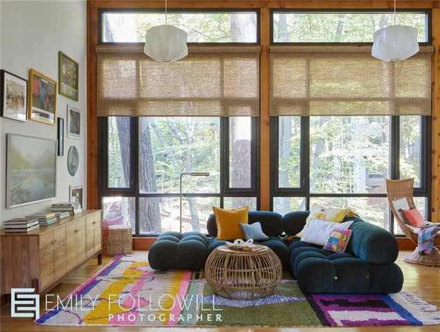 a living room filled with furniture and a floor to ceiling window