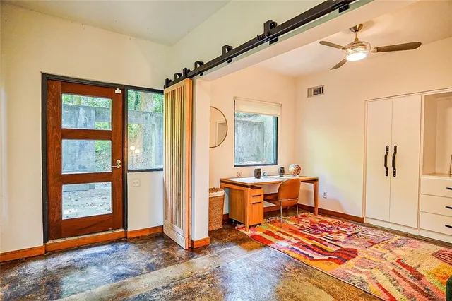 a view of a livingroom with furniture and windows