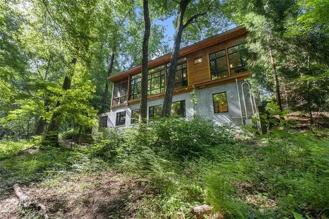 a front view of a house with a tree