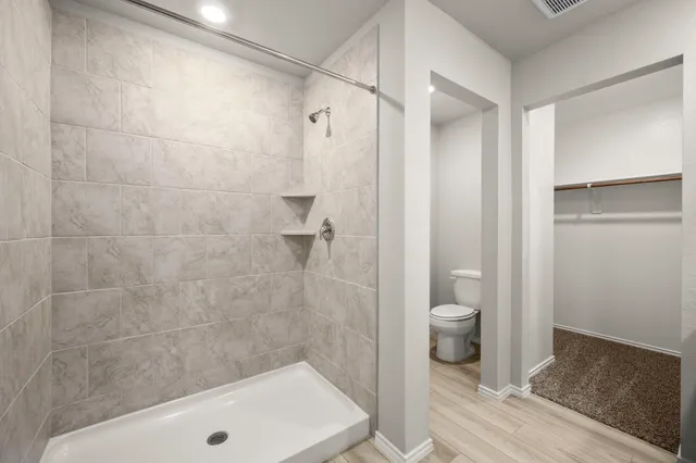 a bathroom with a shower and a toilet