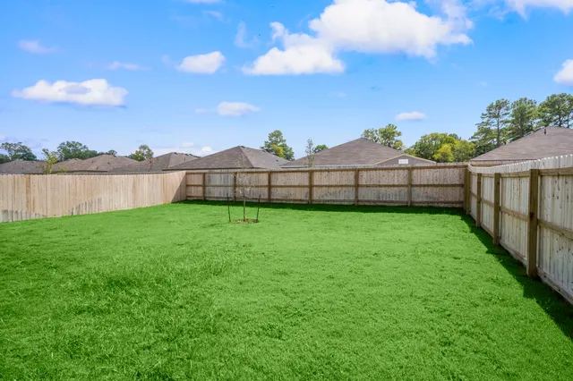 a view of a backyard with a garden and deck