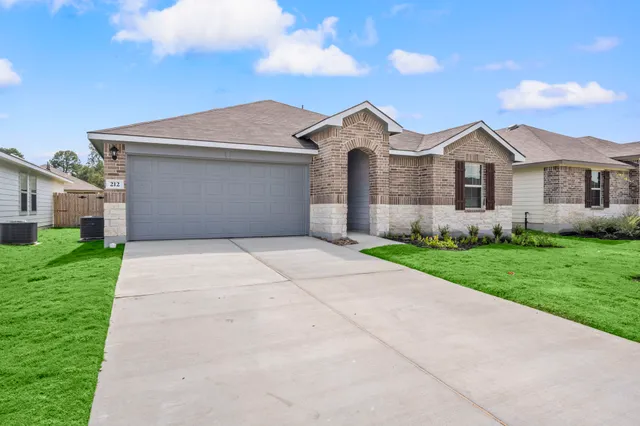 a front view of house with yard and green space