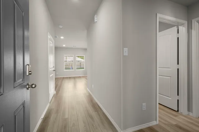 a view of gallery with wooden floor