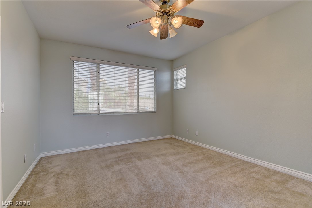1813 Snow Spring Lane Las Vegas, NV 89134 - Photo 22 of 37 A comfortable bedroom with carpet flooring and windows for abundant natural light.