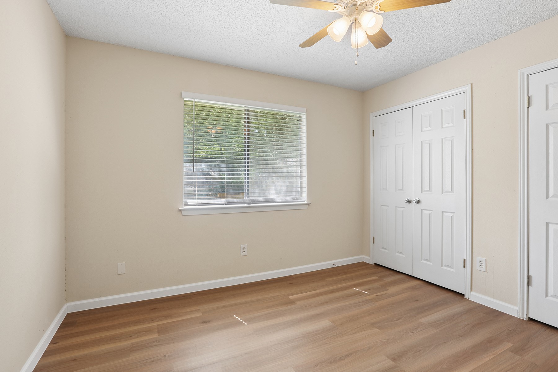 3114 Plantation Road, Unit A Austin, TX 78745 - Photo 12 of 15 A well-lit bedroom with durable hardwood-style flooring awaits your personal touch.