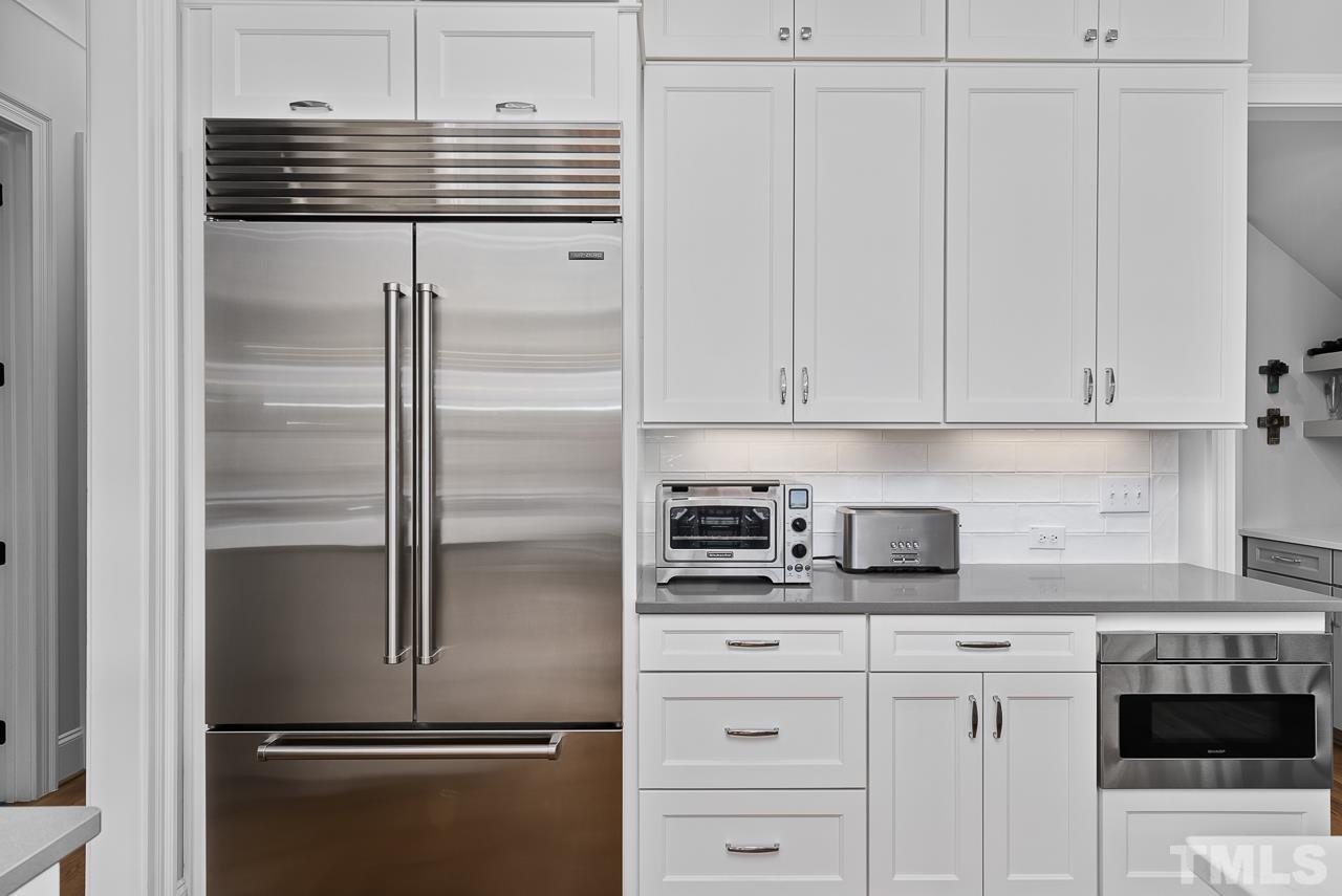 1709 Montvale Grant Way Apex, NC 27523 - Photo 19 of 68 a kitchen with appliances and cabinets