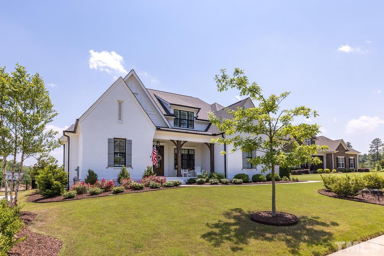 1709 Montvale Grant Way Apex, NC 27523 - Photo 2 of 68 a front view of a house with swimming pool and yard