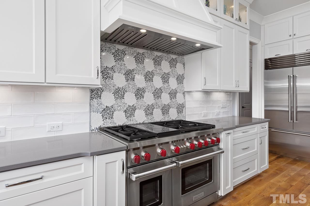 1709 Montvale Grant Way Apex, NC 27523 - Photo 21 of 68 a kitchen with stainless steel appliances granite countertop a stove and a refrigerator