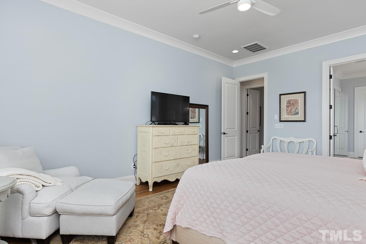 1709 Montvale Grant Way Apex, NC 27523 - Photo 25 of 68 a bedroom with a bed and a television