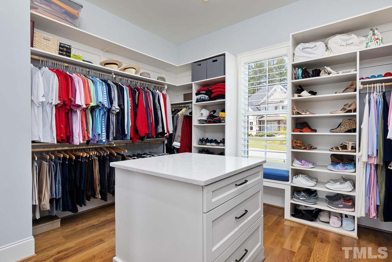 1709 Montvale Grant Way Apex, NC 27523 - Photo 29 of 68 a view of walk in closet with clothes and shoes