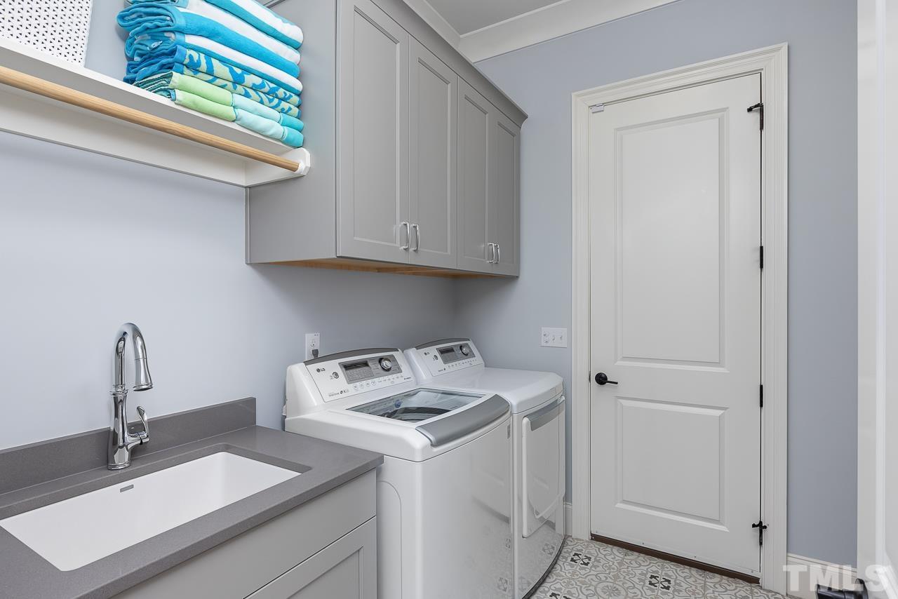 1709 Montvale Grant Way Apex, NC 27523 - Photo 32 of 68 a view of a storage and utility room with a sink