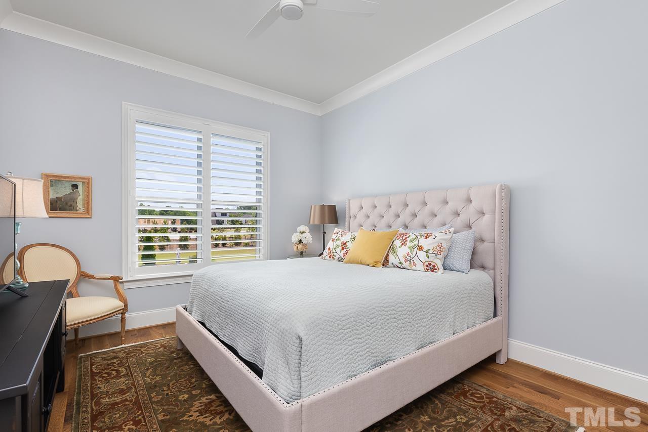 1709 Montvale Grant Way Apex, NC 27523 - Photo 34 of 68 a bed sitting in a bedroom next to a window