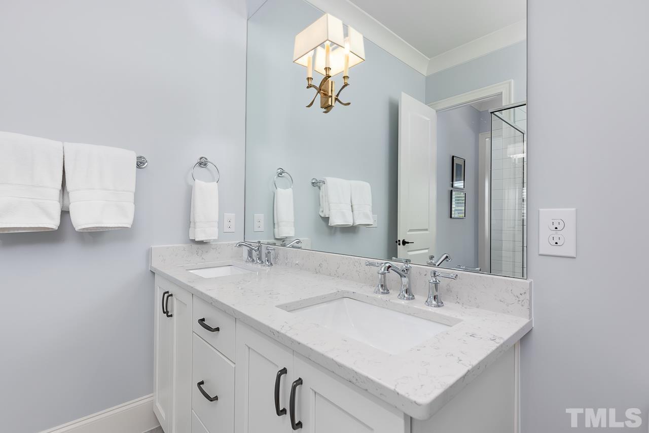 1709 Montvale Grant Way Apex, NC 27523 - Photo 35 of 68 a bathroom with a sink and a mirror