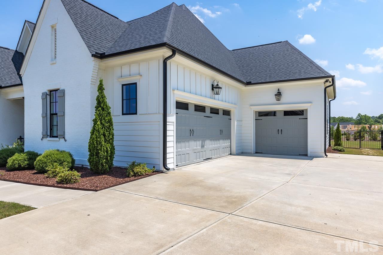 1709 Montvale Grant Way Apex, NC 27523 - Photo 4 of 68 a front view of a house with a yard and garage