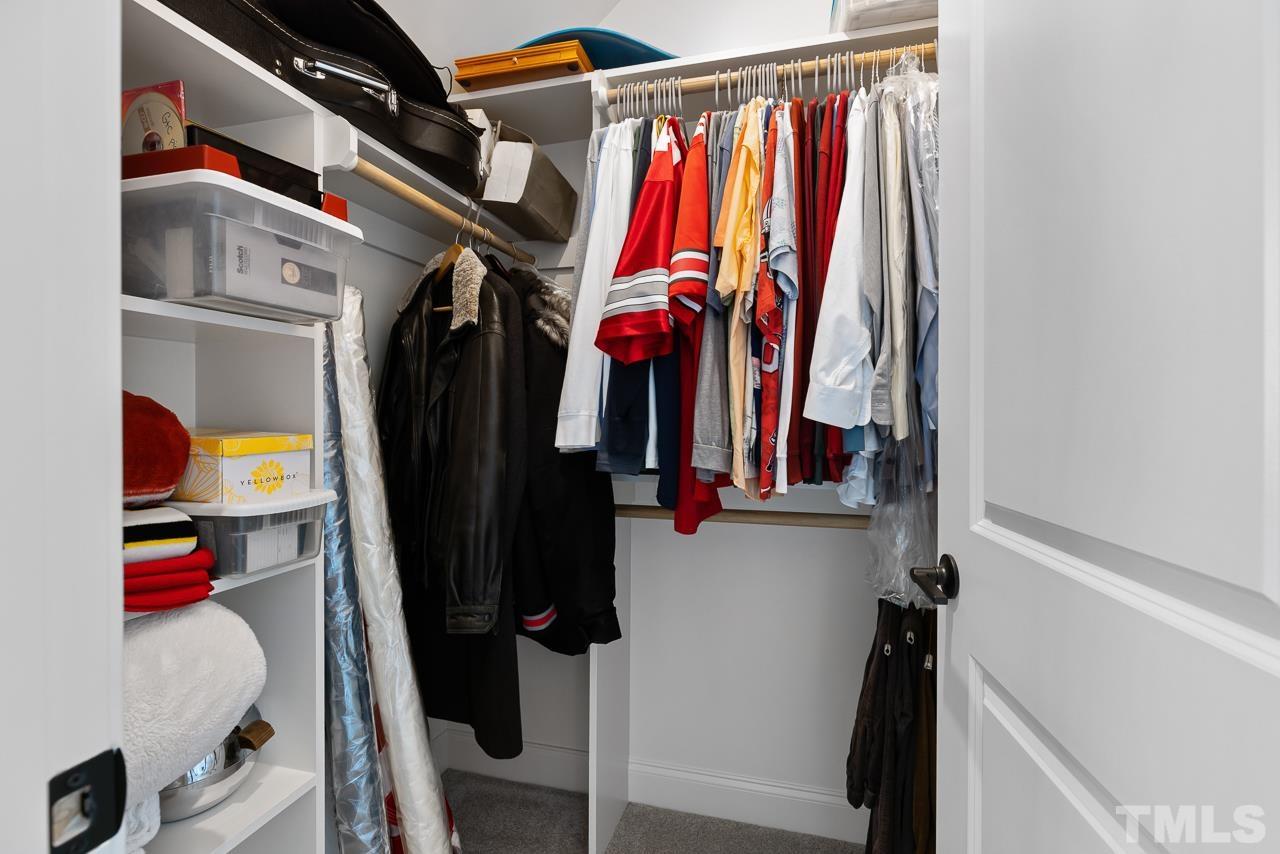 1709 Montvale Grant Way Apex, NC 27523 - Photo 41 of 68 a view of walk in closet with clothes and shoes