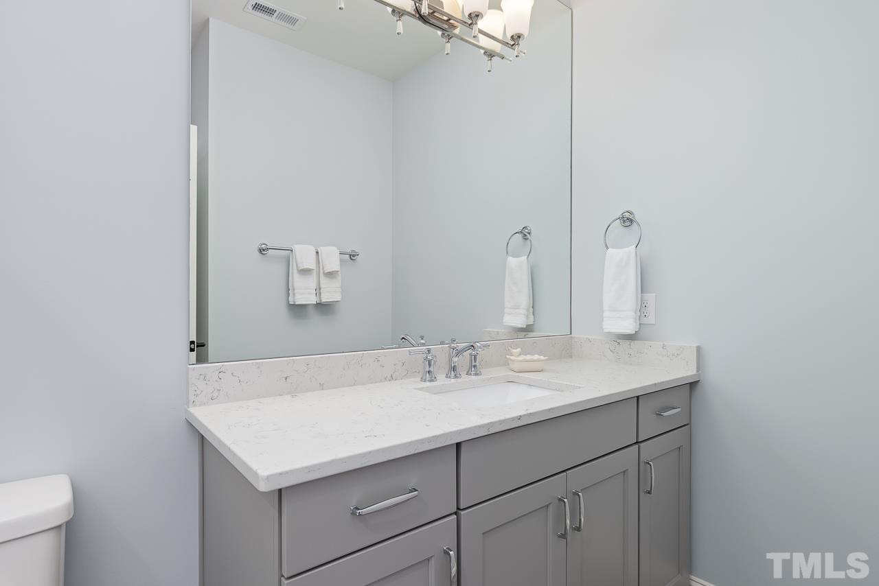 1709 Montvale Grant Way Apex, NC 27523 - Photo 43 of 68 a bathroom with a sink and a mirror