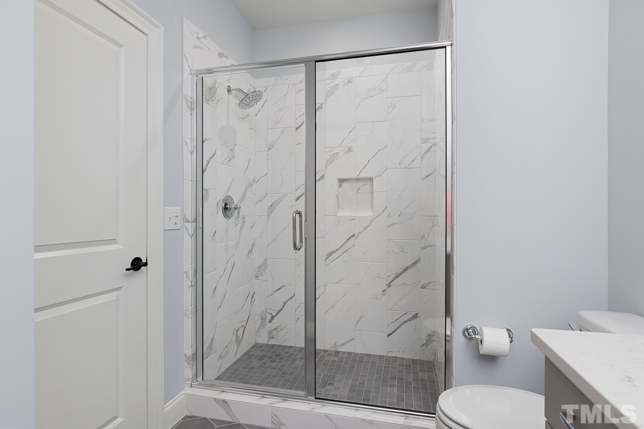 1709 Montvale Grant Way Apex, NC 27523 - Photo 44 of 68 a bathroom with a shower and toilet