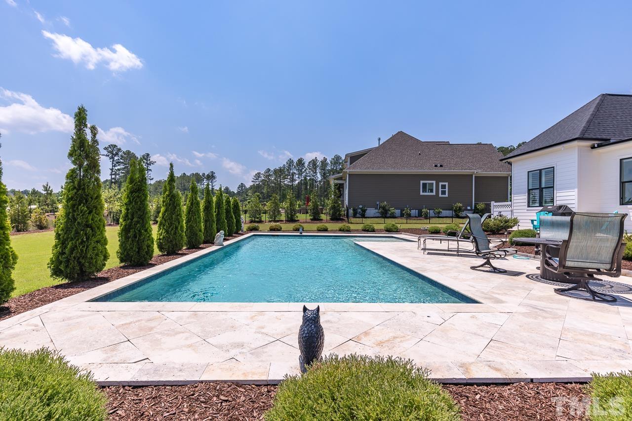 1709 Montvale Grant Way Apex, NC 27523 - Photo 54 of 68 a swimming pool with outdoor seating and yard