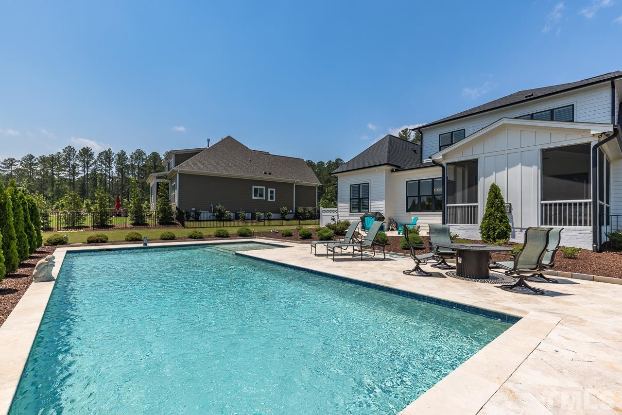 1709 Montvale Grant Way Apex, NC 27523 - Photo 55 of 68 a view of patio with table and chairs under an umbrella