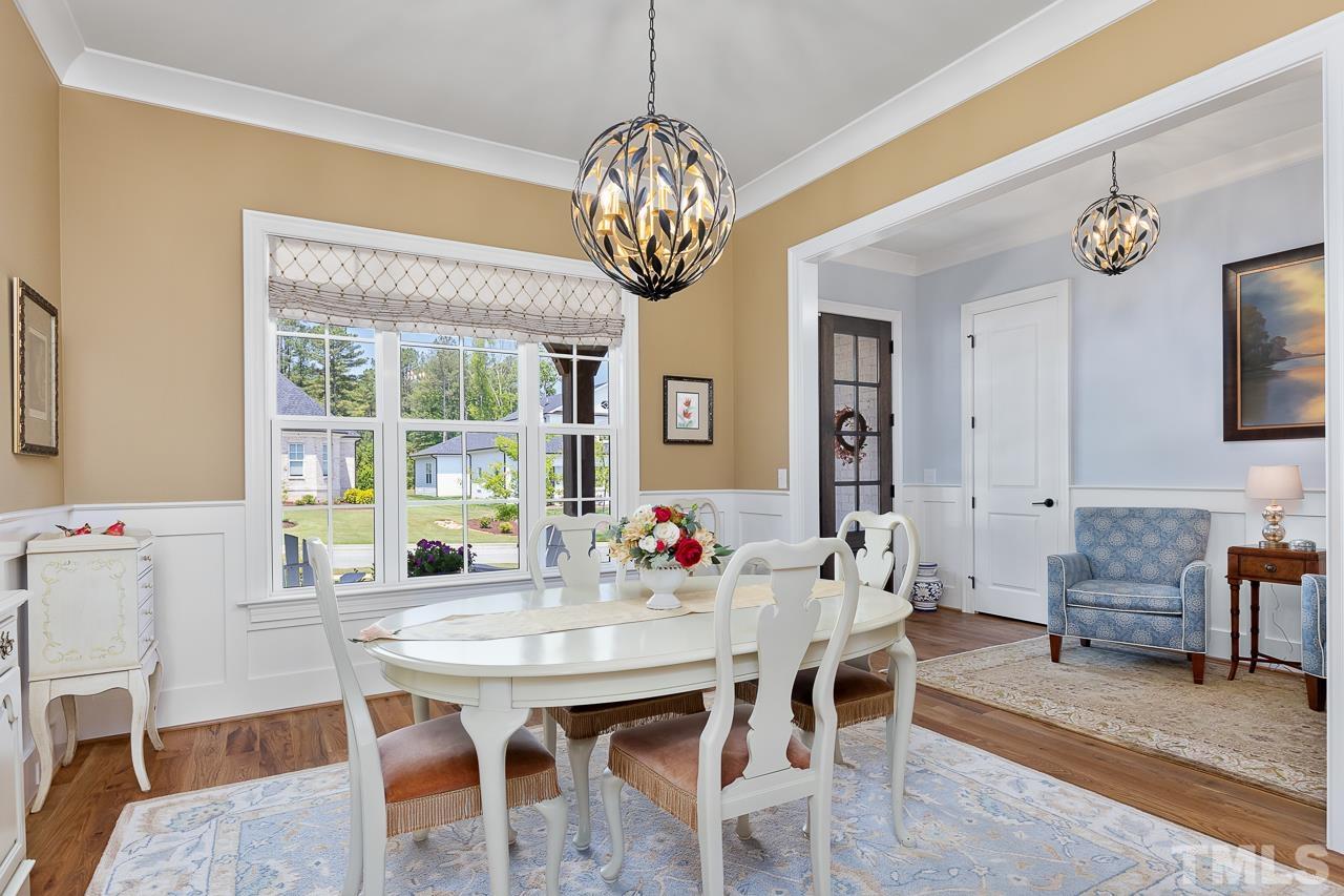 1709 Montvale Grant Way Apex, NC 27523 - Photo 9 of 68 a view of a dining room with furniture window and wooden floor