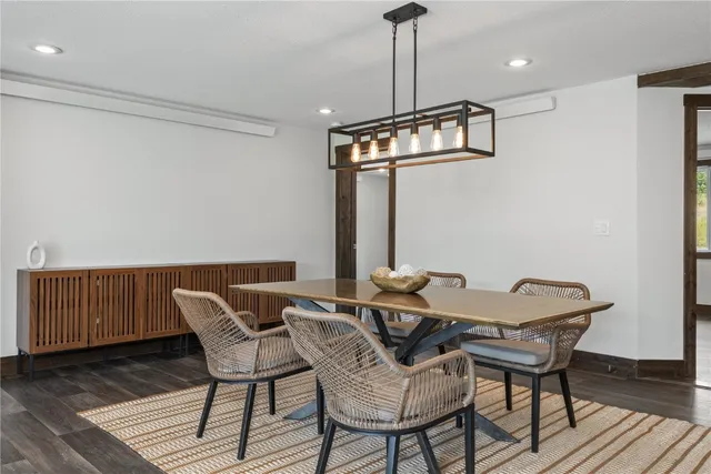 a view of a dining room with furniture wooden floor and chandelier