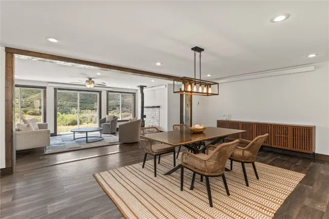 a dining room with furniture window and wooden floor