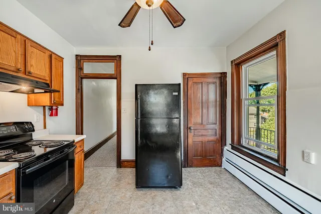 a kitchen with stainless steel appliances granite countertop a refrigerator a stove and a sink