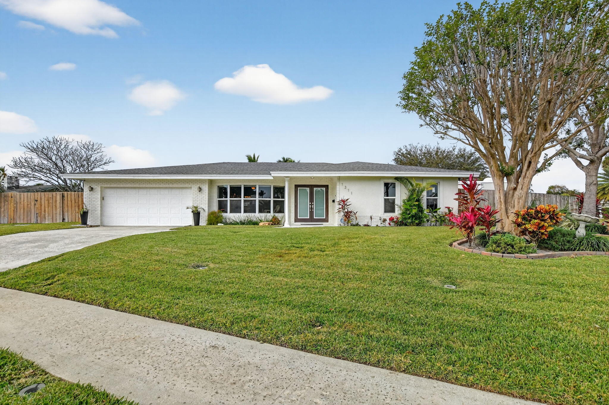 a front view of a house with a garden