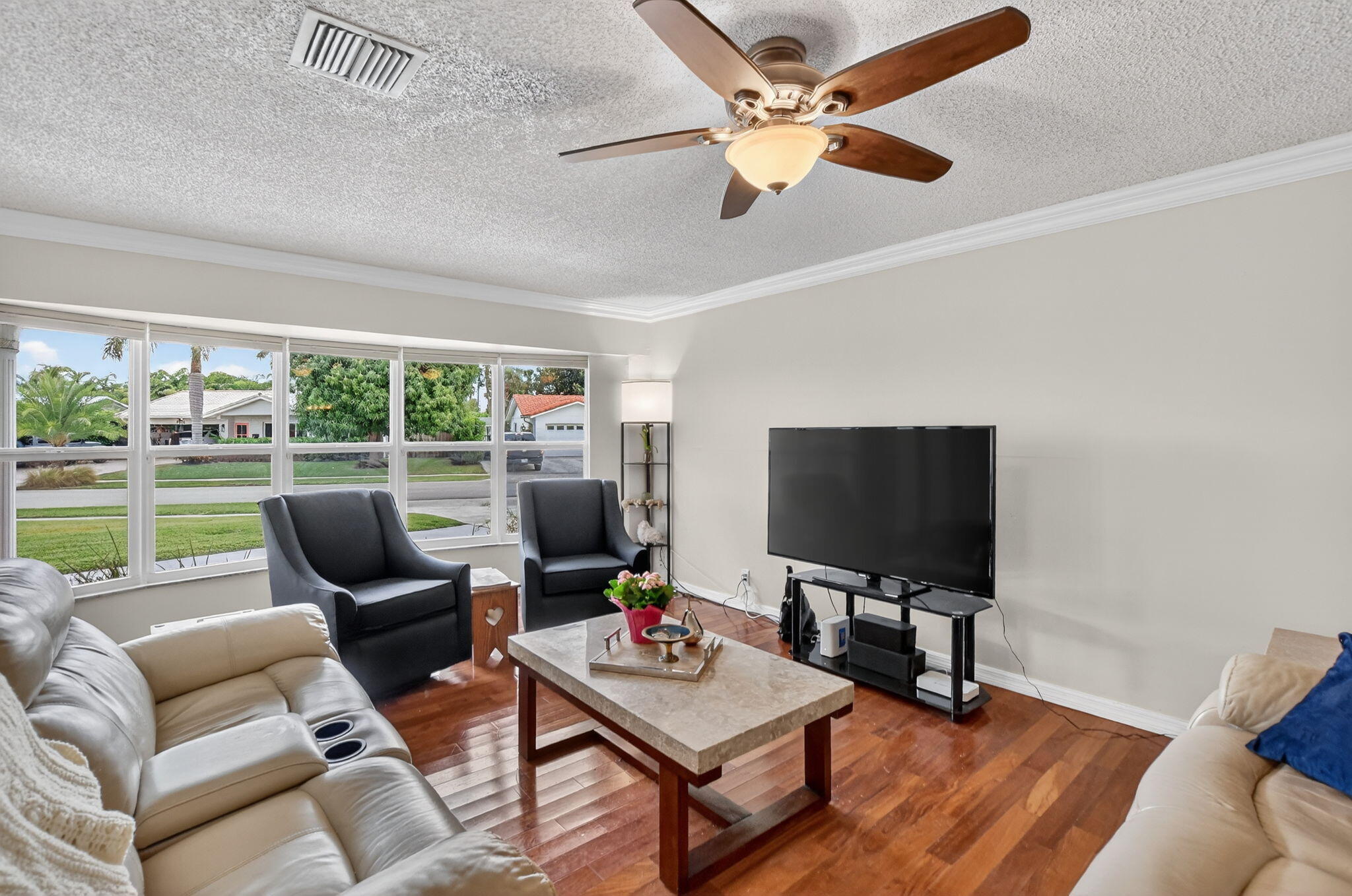 1311 Southwest 14th Avenue Boca Raton, FL 33486 - Photo 11 of 54 a living room with furniture and a flat screen tv