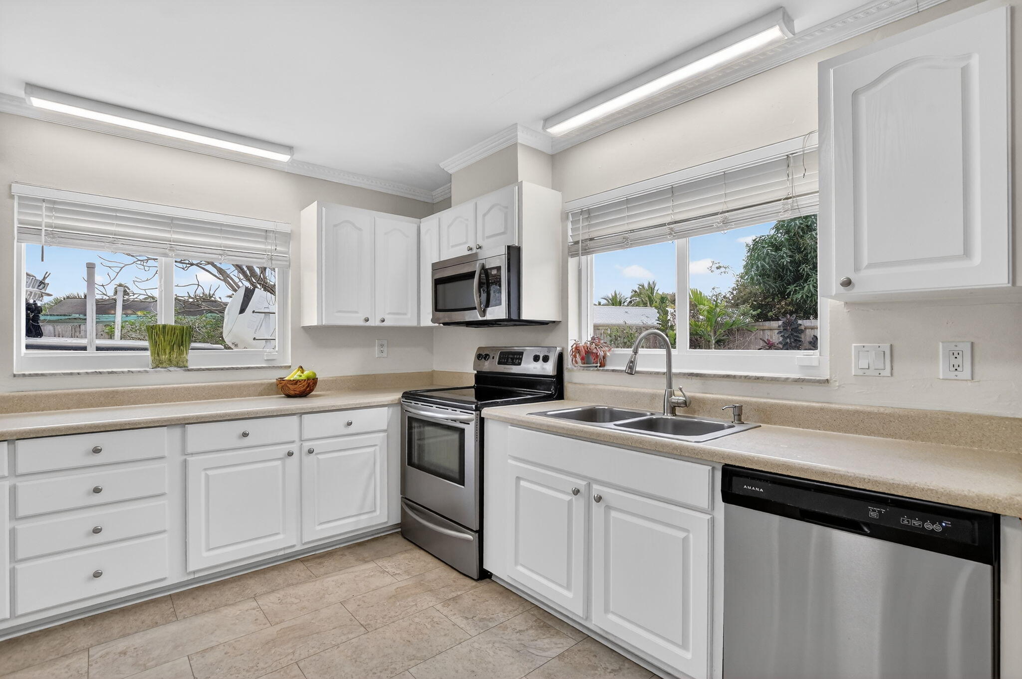 1311 Southwest 14th Avenue Boca Raton, FL 33486 - Photo 18 of 54 a kitchen with white cabinets sink and window