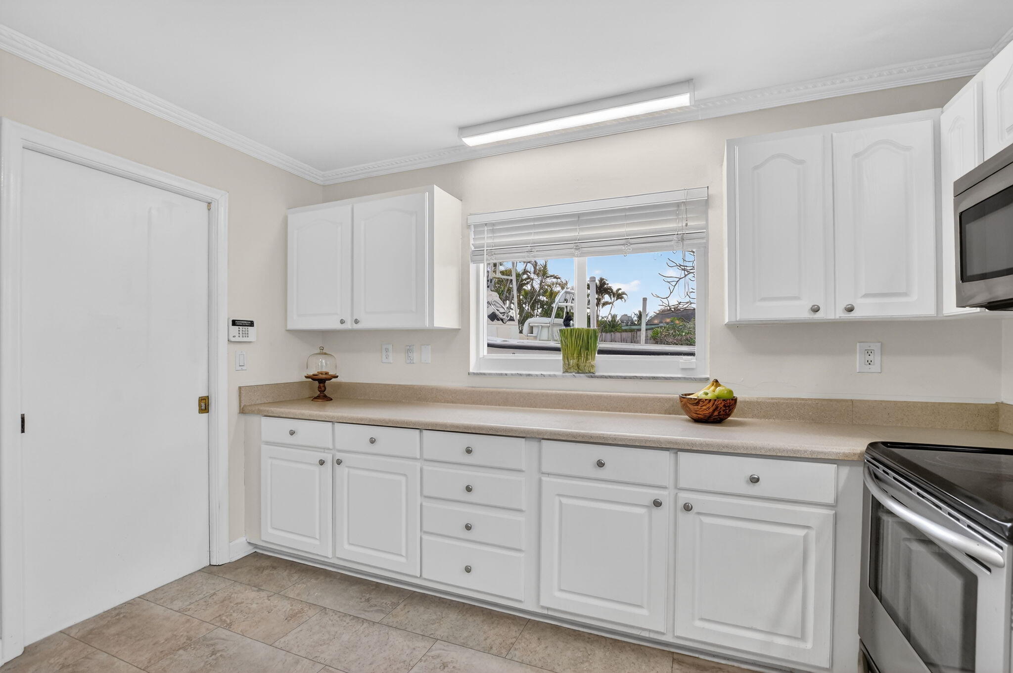 1311 Southwest 14th Avenue Boca Raton, FL 33486 - Photo 19 of 54 a kitchen with white cabinets and white appliances