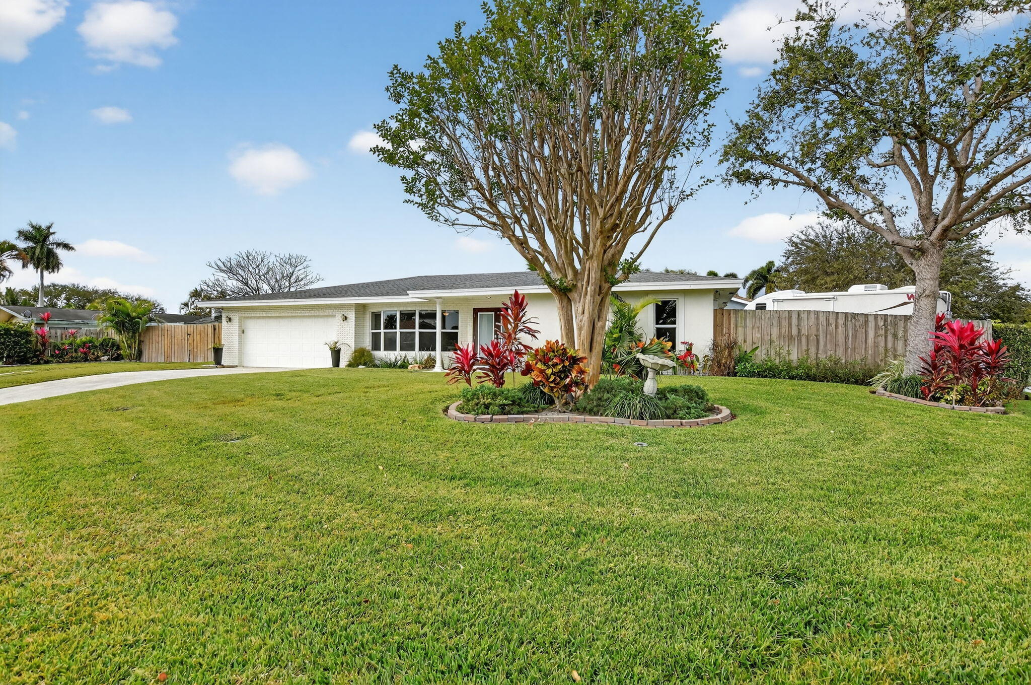 1311 Southwest 14th Avenue Boca Raton, FL 33486 - Photo 2 of 54 a front view of house with yard and green space