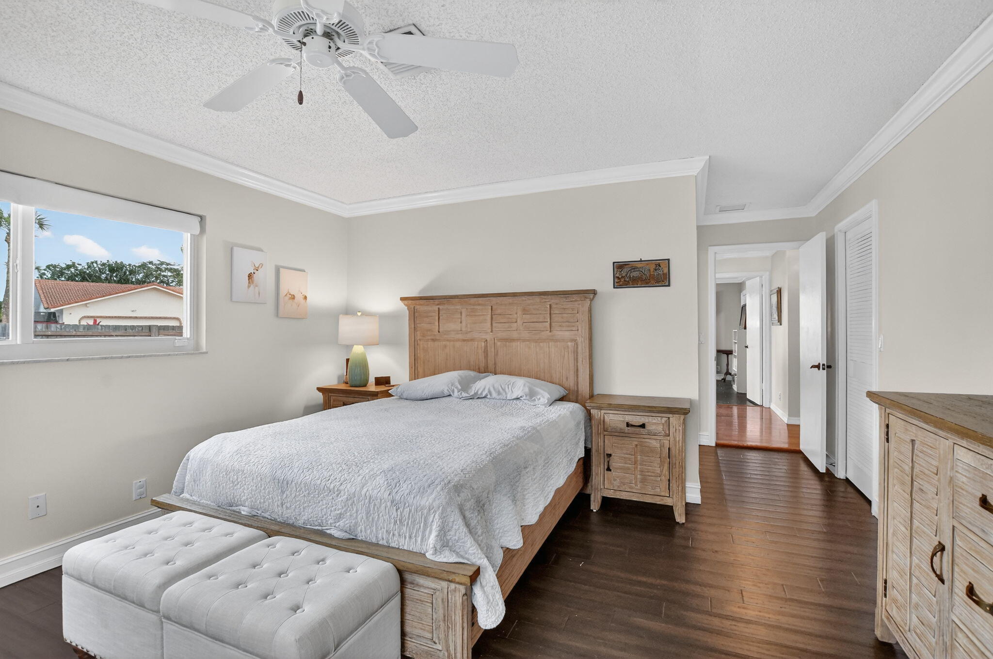 1311 Southwest 14th Avenue Boca Raton, FL 33486 - Photo 22 of 54 a bedroom with a bed and a chandelier