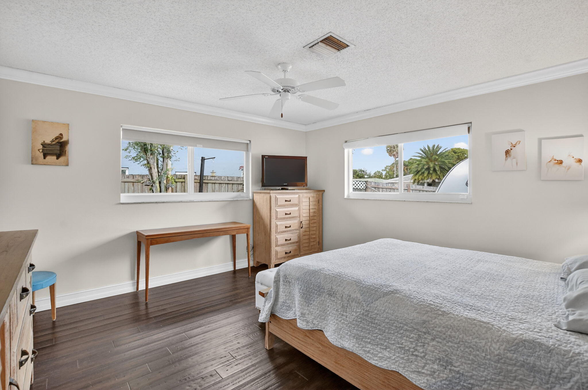 1311 Southwest 14th Avenue Boca Raton, FL 33486 - Photo 24 of 54 a bedroom with a bed table and a window
