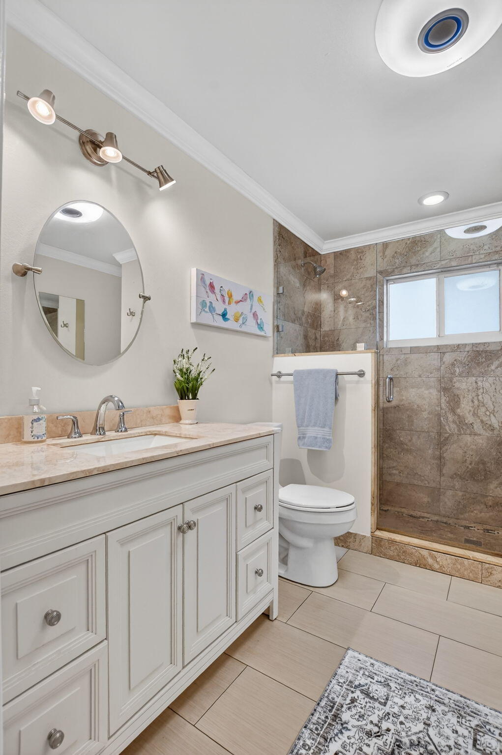 1311 Southwest 14th Avenue Boca Raton, FL 33486 - Photo 26 of 54 a bathroom with a toilet a sink a mirror and a shower