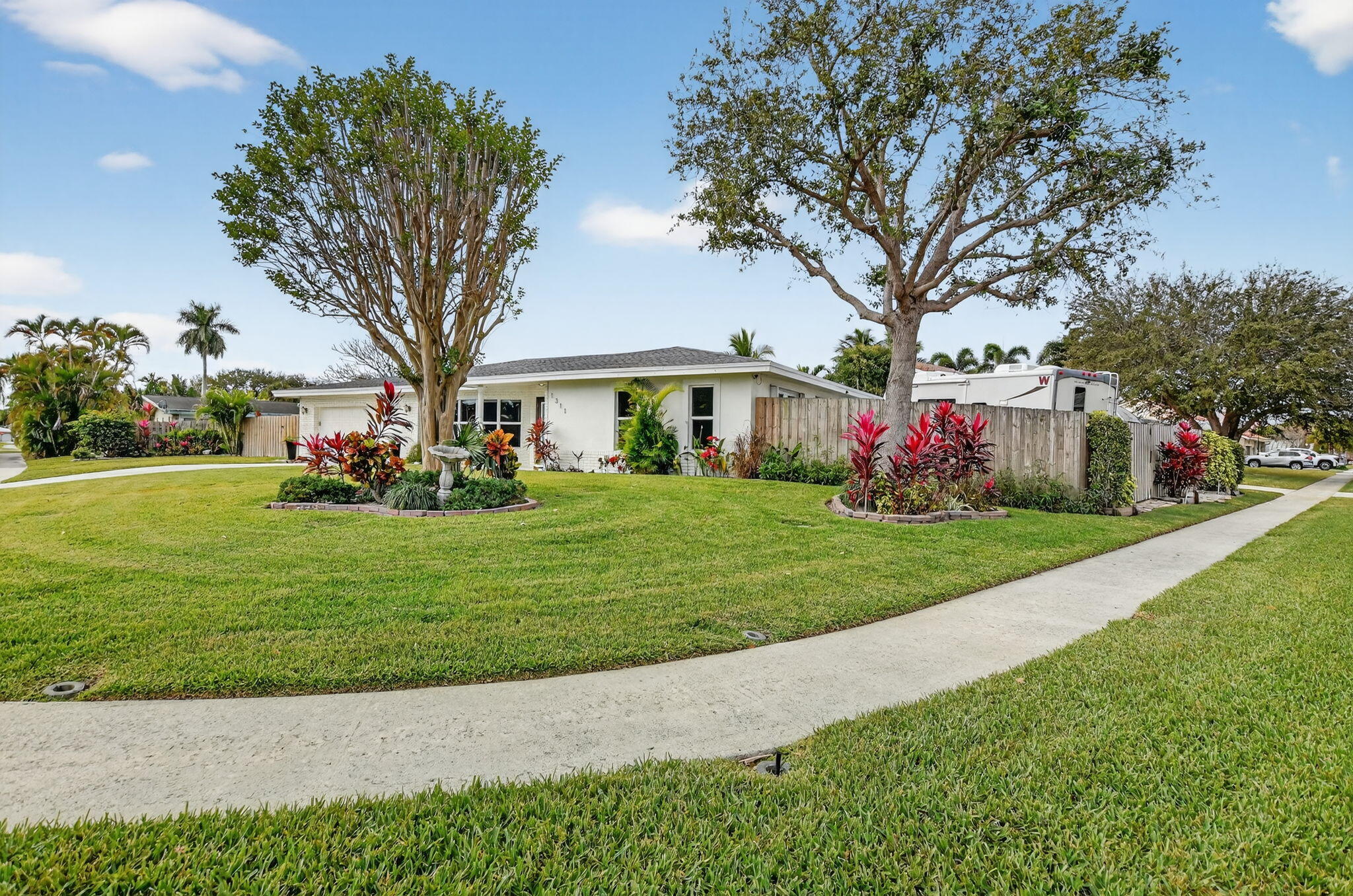 1311 Southwest 14th Avenue Boca Raton, FL 33486 - Photo 3 of 54 a front view of house with yard and green space