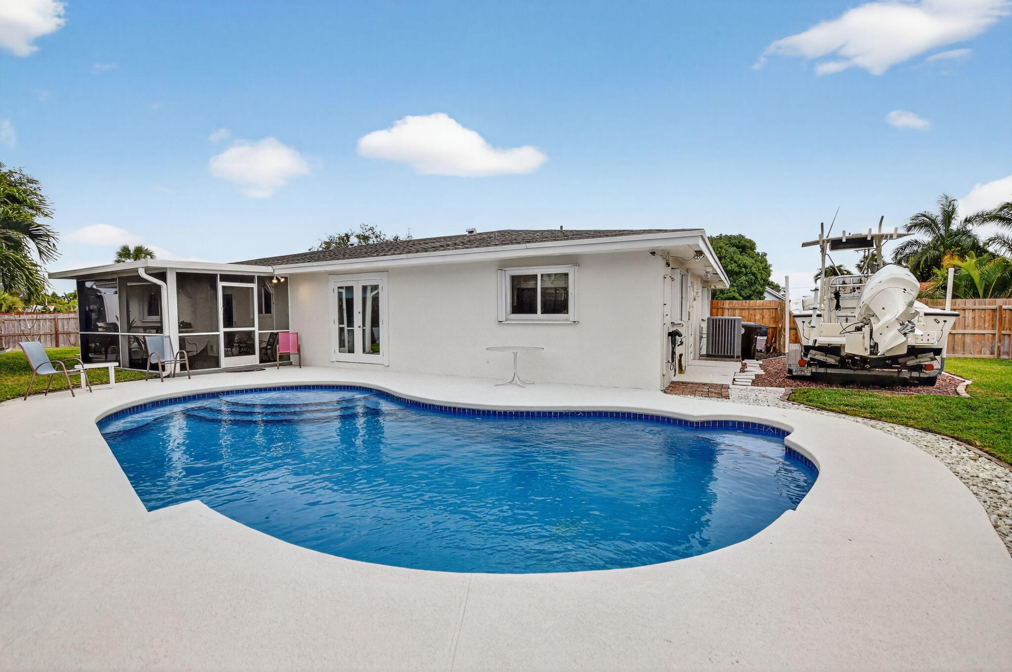 1311 Southwest 14th Avenue Boca Raton, FL 33486 - Photo 42 of 54 a view of a house with swimming pool