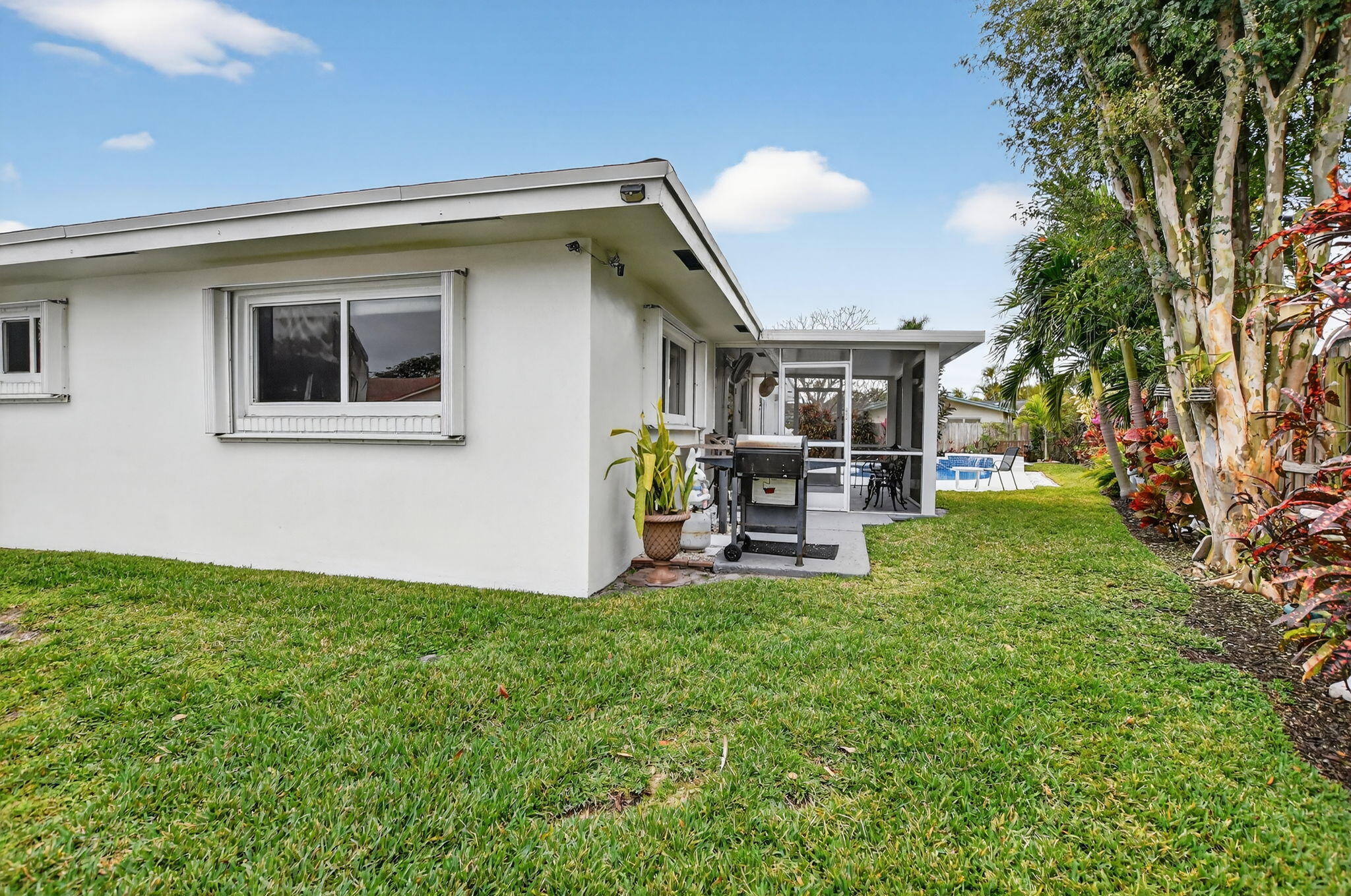 1311 Southwest 14th Avenue Boca Raton, FL 33486 - Photo 44 of 54 a backyard of a house with table and chairs