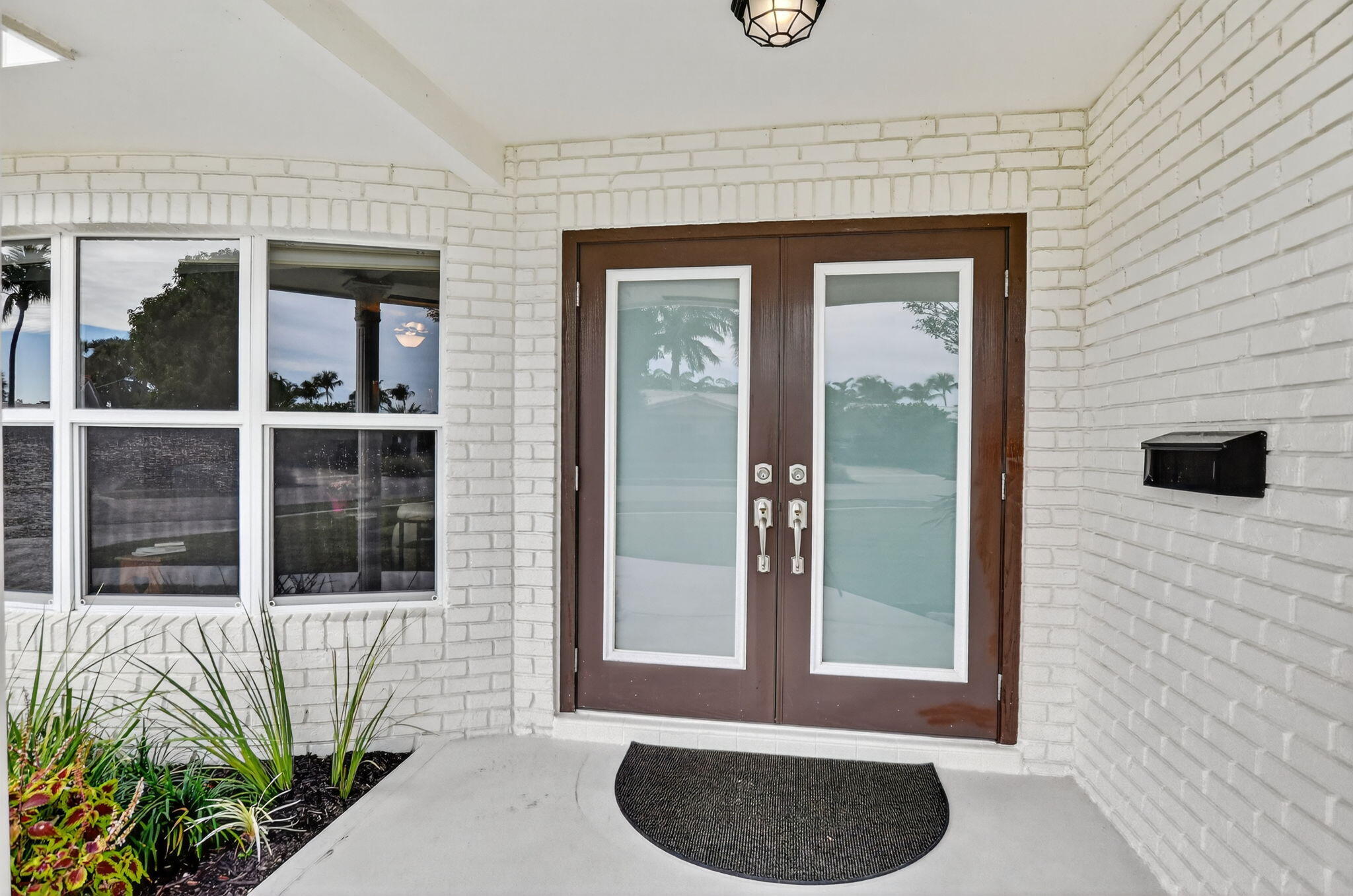 1311 Southwest 14th Avenue Boca Raton, FL 33486 - Photo 5 of 54 a front view of a house with a window