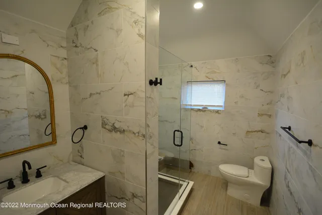 a bathroom with a toilet sink and shower